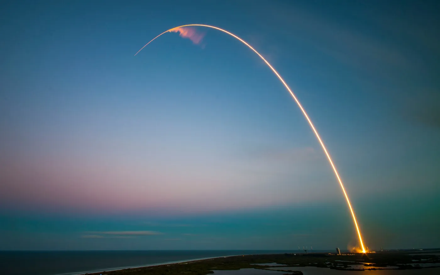 rocket launch light trail at dusk by SpaceX courtesy of Unsplash.